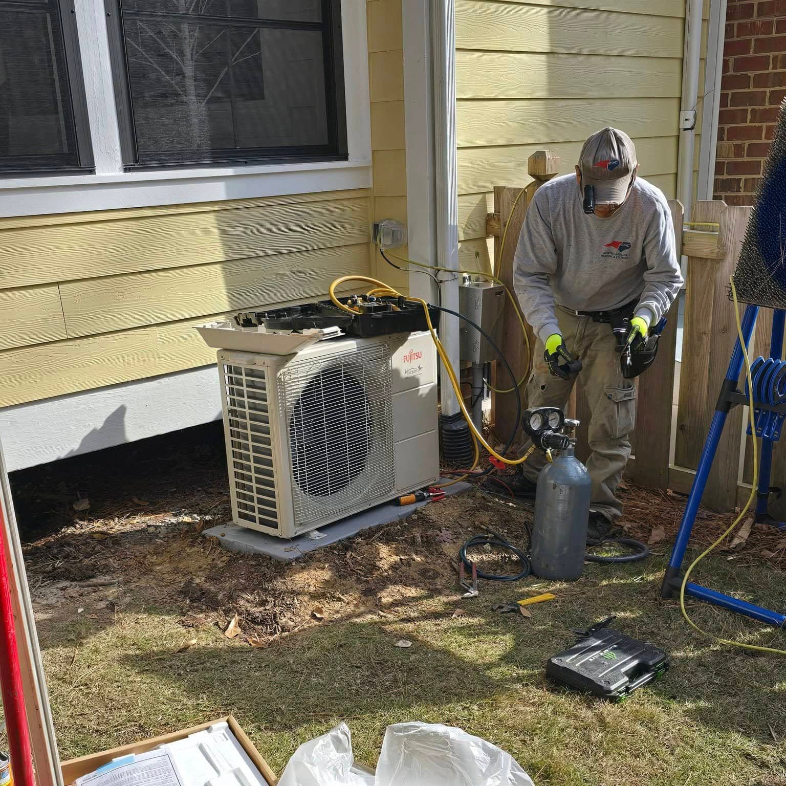 HVAC technician performing an air conditioning installation in Cary, NC