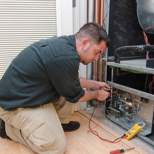 HVAC technician performing an air conditioning installation in Cary, NC