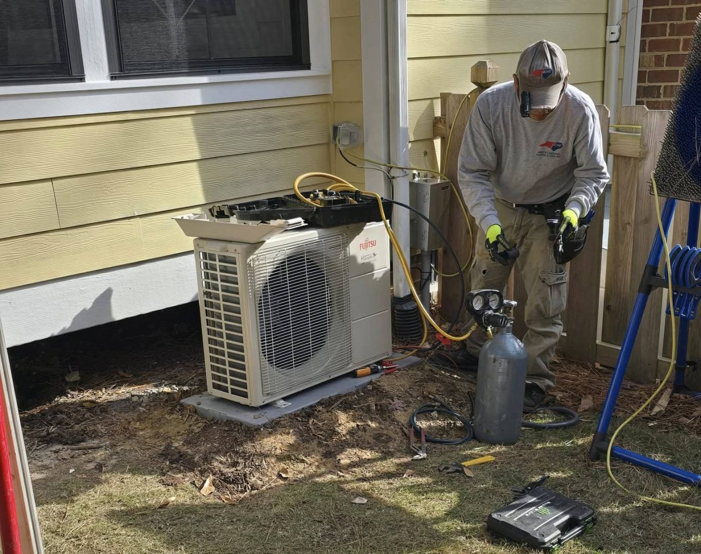 HVAC technician performing an air conditioning installation in Cary, NC